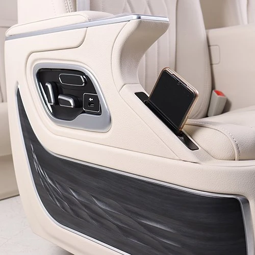Phone storage box on van seat armrest Phone storage box on van seat armrest
